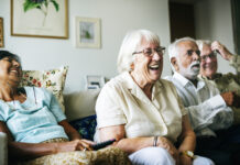 Senior people watching televison together